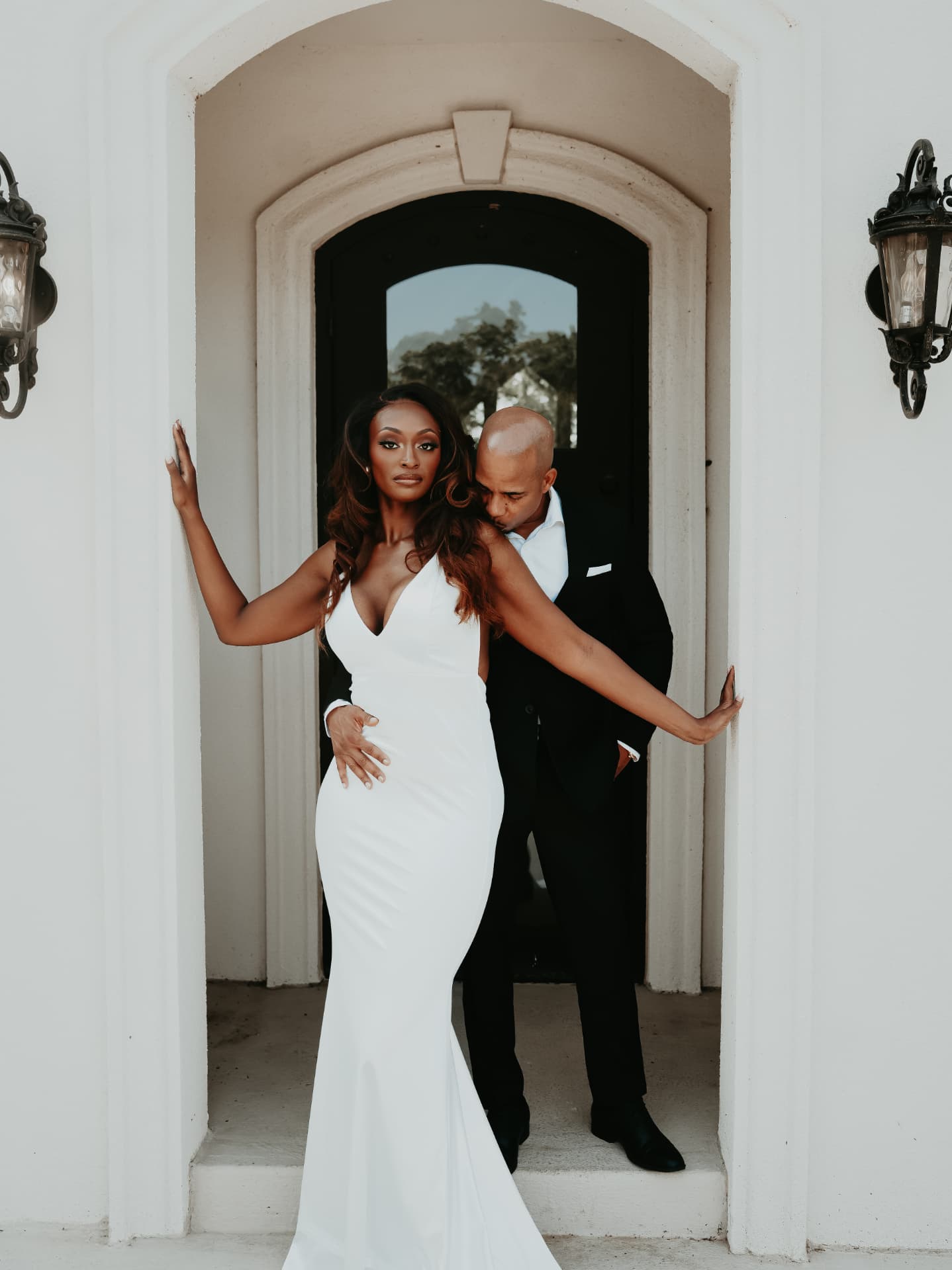 A Just Elope couple embracing in an arched doorway