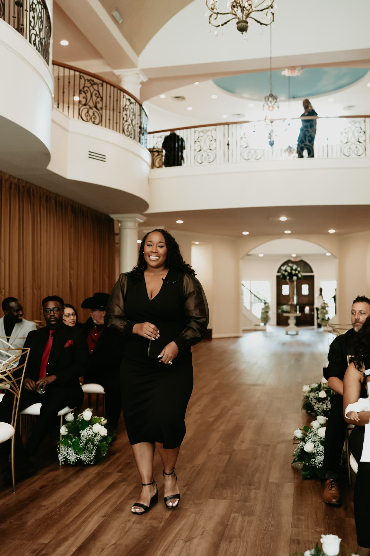 Jennifer Allen walking down the aisle before a ceremony
