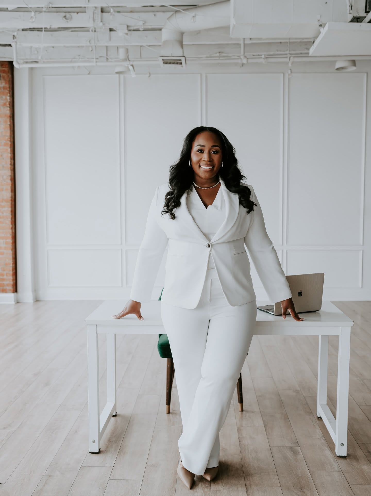 Jennifer Allen, founder of Just Elope, in a white suit
